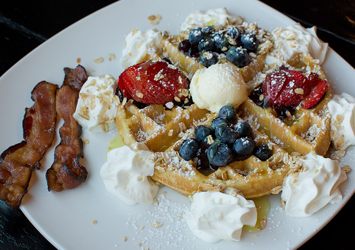 Berries and Lemon Curd Waffle with a Side of Bacon at JavaVino in La Crosse, Wisconsin.